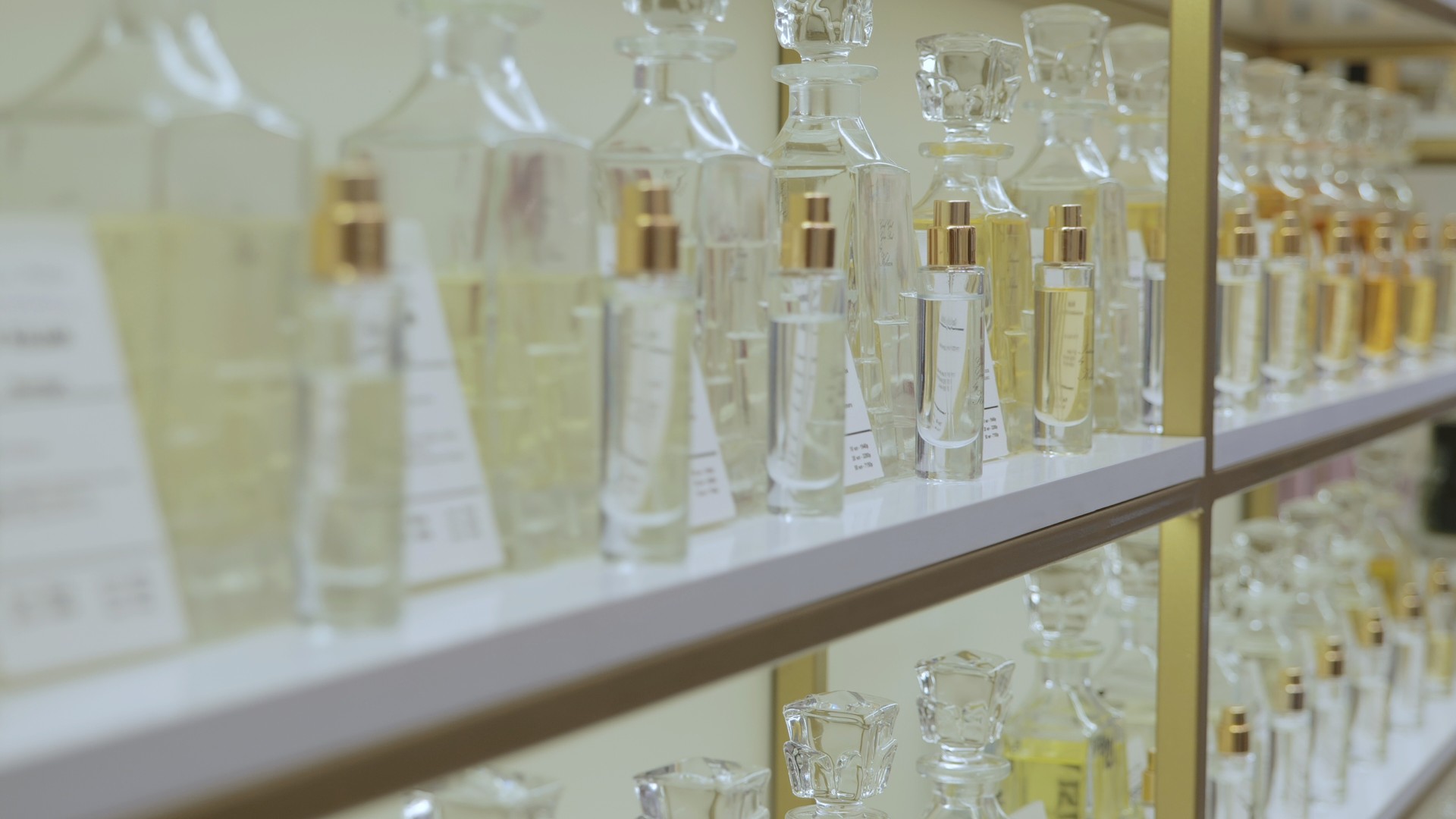 Perfume rack. Luxurious perfume in a cosmetics store. Choosing the right scents. Women's Shopping in Luxury Boutique Store